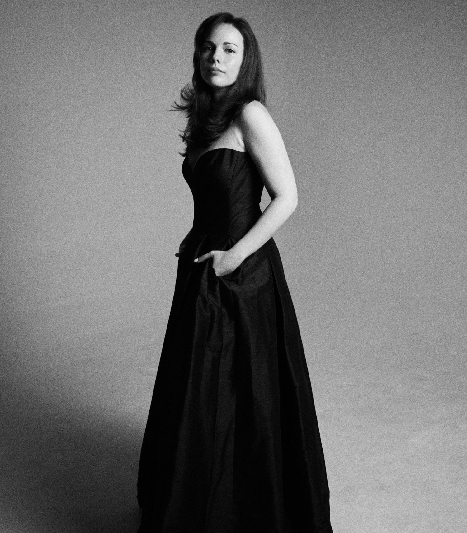 Alexandra Yangel standing in a long black dress in the studio