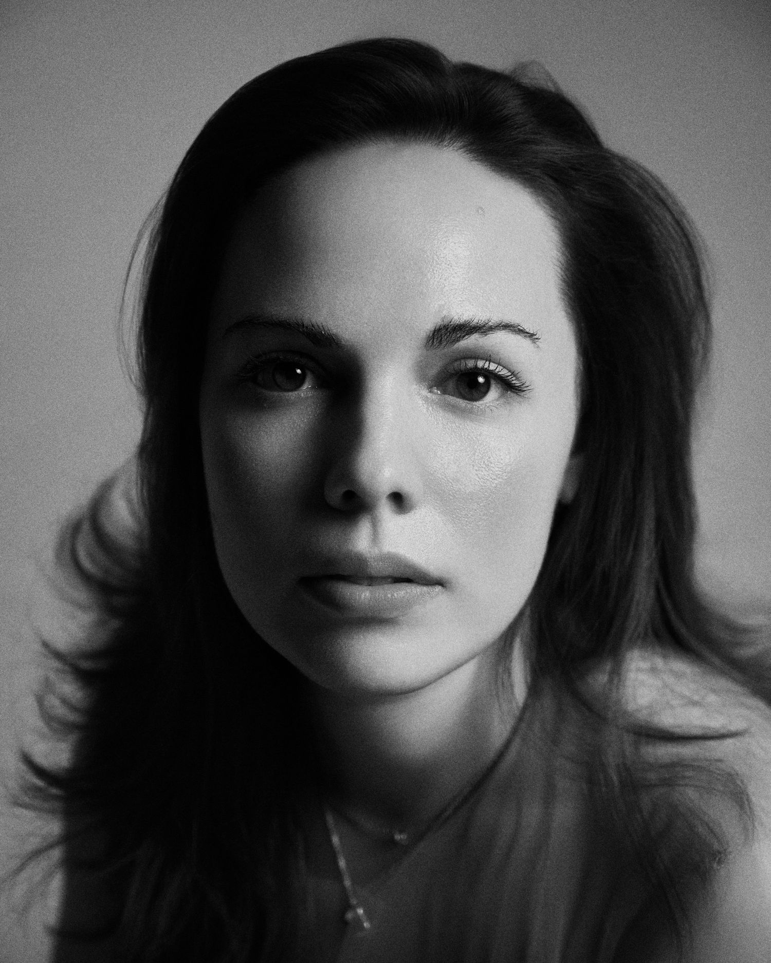 Alexandra Yangel, close studio portrait against a grey backdrop