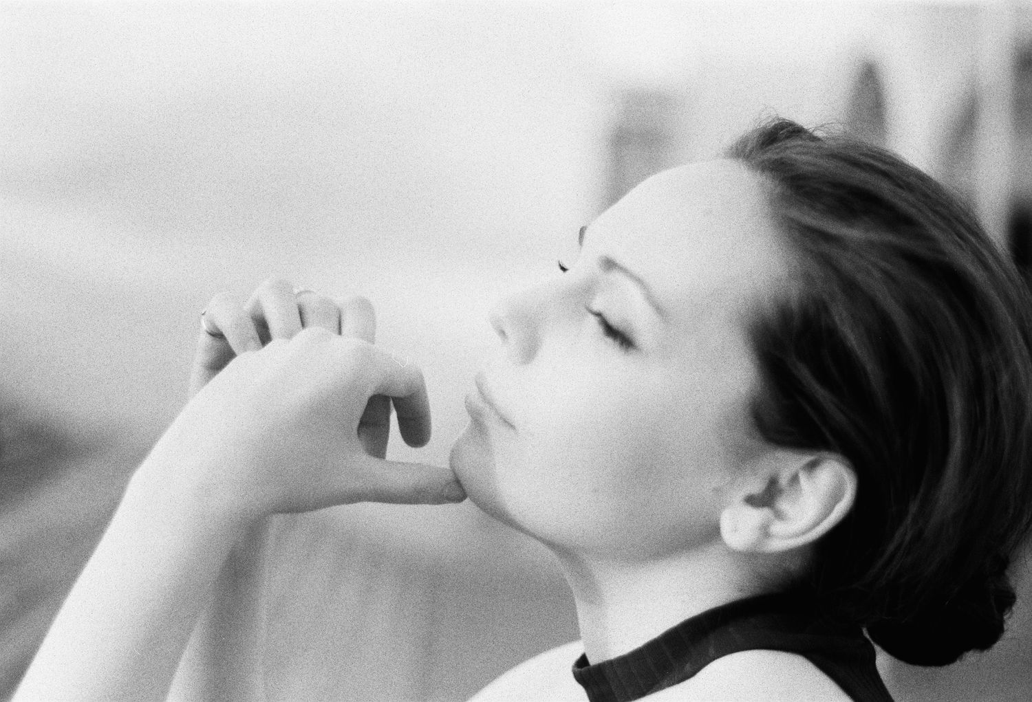 Alexandra Yangel with her eyes closed, her hands clasped at her lips