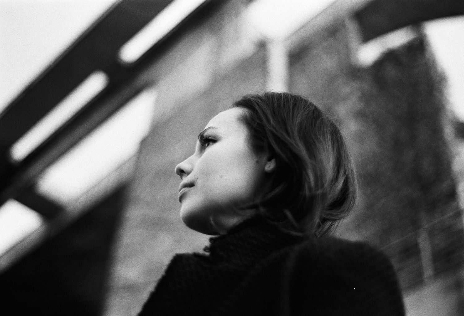 Alexandra Yangel in profile, looking upward, steel girders behind her